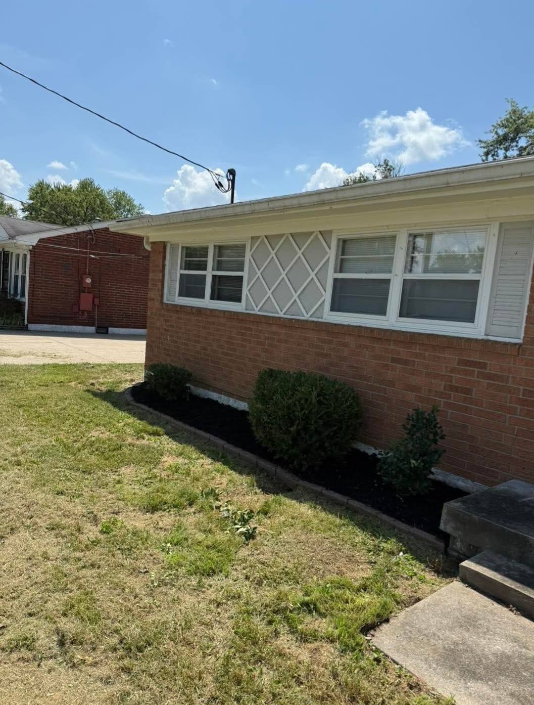 Clean trimmed shrubs and mulch beds after landscaping